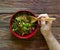 Wooden spoon in the men\'s hand and plate with buckwheat porridge with meat