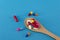 Wooden spoon with multicolored pills medicines with blue