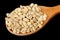 Wooden Spoon with Pearl Barley on Black Background