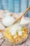 Wooden spoon pouring yogurt on corn flakes with green apple and