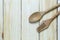 wooden spoon rests on a brown wood floor.