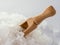 Wooden spoon in sea salt. The crystals of sea salt close up.