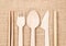 Wooden spoon set and straw bamboo tube on sack background