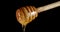 With a wooden spoon slowly drains fresh honey.