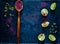 Wooden spoon with spice sumac and citrus fruit lime on vintage rusty metal background, ingredients for salads, top view