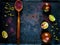 Wooden spoon with spice sumac, tomatoes of kumato and citrus fruit lime on vintage rusty metal background, ingredients for salads