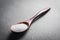 Wooden Spoon With White Grain Sugar On Slate Stone, Side View