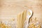 Wooden spoons, different pasta on knitted lace tablecloth