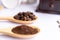 wooden spoons filled with crushed ground coffee on white background, close up