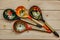 Wooden spoons with floral ornament in traditional folk Russian Khokhloma style on wooden table