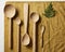 Wooden spoons and a leaf on a napkin