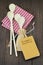 Wooden spoons on red gingham tablecloth and a small notebook