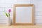 Wooden square frame mockup with pink tulip