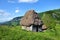 Wooden stable with thatched roof in the mountains
