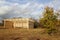 Wooden stables - shelter for domesticated animals on a pasture in the open countryside