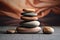 a wooden stack of round smooth stones on a yoga mat