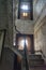 Wooden stair case in boarded up, dilapidated house