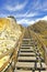 Wooden staircase at the Cliff of Asperillo in Cuesta Maneli beach, very close to Mazagon in province of Huelva, Andalusia, Spain