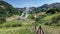 A wooden staircase descends into the Valley of Geysers.