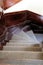 Wooden staircase looking down with carpeted steps