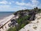 Wooden staircase of vantage point at seaside landscape at TULUM city in Mexico near archaeological site with tourists