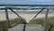 Wooden stairs on beach and Baltic sea waves