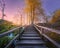 Wooden stairs in forest at sunset in autumn. Plitvice Lakes