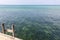 Wooden stairs to the sea with aquamarine water. Empty wooden pier at the Indian ocean coast. Tropical vacations.