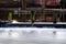 Wooden stakes stuck in a pond in the park. Blurred running water. Odense. Denmark