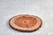 Wooden stand for a dish on a concrete background. A saw cut of a tree trunk to showcase a product presentation