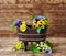 Wooden stand flowerpot with flowers yellow and purple pansies on a wooden brown background