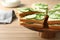 Wooden stand with traditional English cucumber sandwiches on table