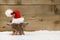 Wooden star with santa hat on wooden background - handmade idea