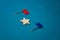 wooden stars and one red on a blue background with a red flag