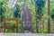 Wooden statue of ancient mythical god near the bench in the park in Thailand.