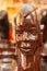 A wooden statue of a man with a mask on his face for sale in Kenya