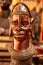 A wooden statue of a man with a mask on his face for sale in Kenya