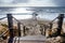 Wooden step leading to a sandy beach, wooden jetty and sea, Southbourne beach, Christchurch, Dorset, England