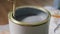 wooden stick stirring grey color paint in can