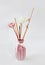 Wooden sticks for aromatherapy in a ceramic pink vase