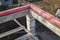 wooden sticks lie on concrete beams, which are based on columns of foam blocks. Preparation of the working space of the house