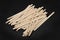 Wooden stirrers for coffee, tea and drinks, on a black background