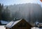 Wooden and stone house in winter. Snowy roofs.