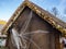 Wooden straw hut with fake spider and web decoration
