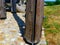 Wooden structural post closeup with steel base plate and big bolt fasteners
