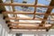 The wooden structure of the building. Installation of wooden beams at construction the roof truss system of the house.