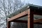 Wooden structure of the bus stop, the shelter of the gazebo pergola. the roof and walls are lined with glass. the glass is anchore