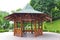 Wooden structure gazebo, in a garden park.