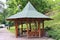 Wooden structure gazebo, in a garden park.