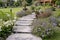 Wooden stump path with beautiful flowers in park.